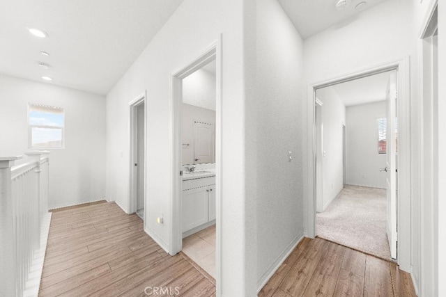 16075 Osprey Ave, Chino, CA 91708 - corridor with light wood-style flooring, plenty of natural light, recessed lighting, and a sink