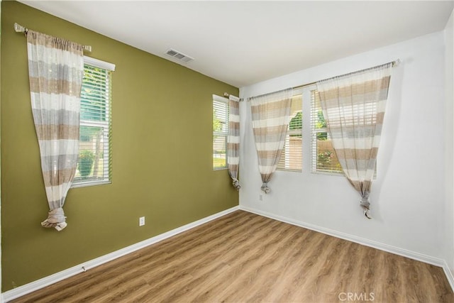 1438 Madrid Dr, Pomona, CA 91766 - empty room with wood finished floors, healthy amount of natural light, and baseboards