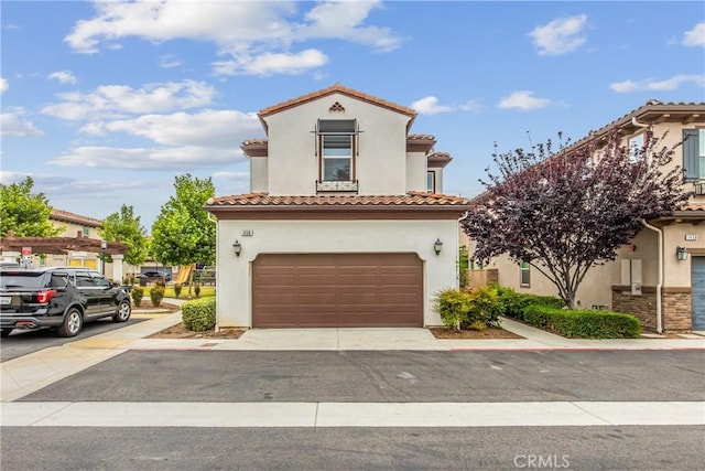 1438 Madrid Dr, Pomona, CA 91766 - mediterranean / spanish house with stucco siding, an attached garage, a tiled roof, and driveway