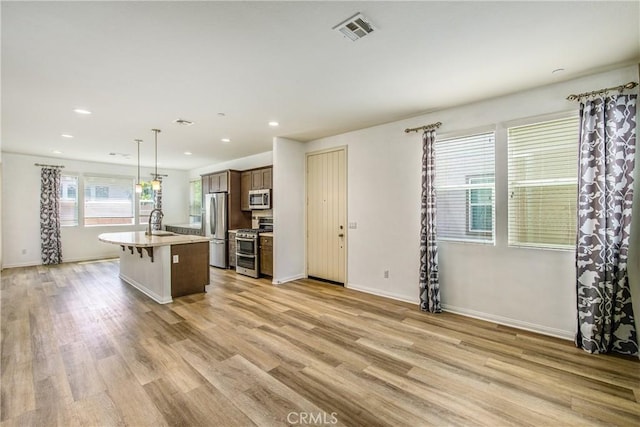 1438 Madrid Dr, Pomona, CA 91766 - kitchen featuring appliances with stainless steel finishes, a sink, recessed lighting, a center island with sink, and a kitchen breakfast bar