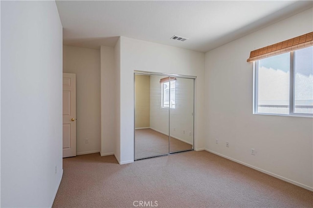 28044 Oakhaven Ln, Menifee, CA 92584 - unfurnished bedroom with carpet flooring, a closet, and baseboards