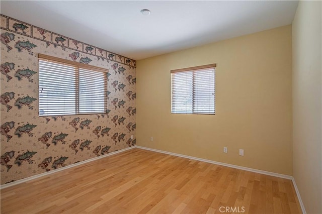 28044 Oakhaven Ln, Menifee, CA 92584 - unfurnished room featuring light wood-style floors, baseboards, and wallpapered walls