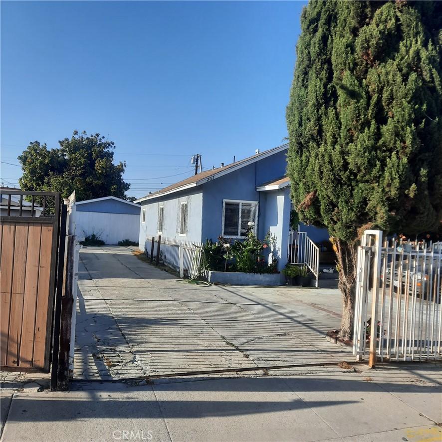 205 W Raymond St, Compton, CA 90220 - view of front of house featuring a gate, stucco siding, and concrete driveway