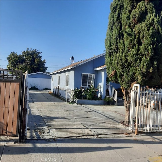 205 W Raymond St, Compton, CA 90220 - view of front of house featuring a gate, stucco siding, and concrete driveway