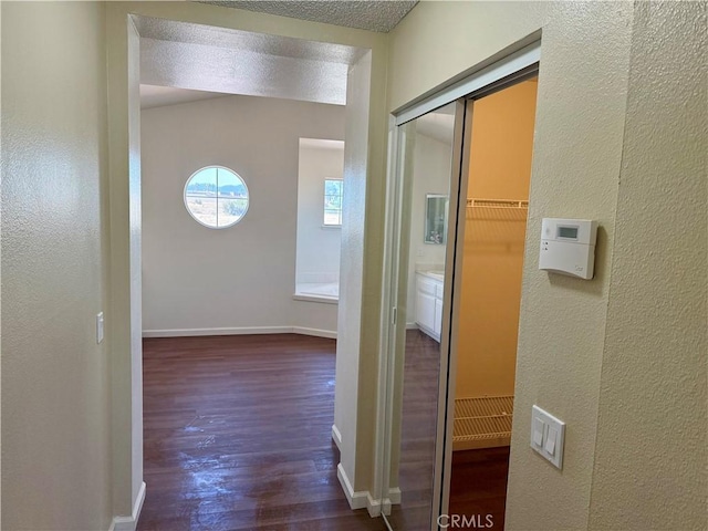 15620 Smoke Tree St, Hesperia, CA 92345 - corridor featuring wood finished floors, a textured wall, and baseboards