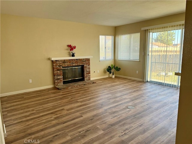 15620 Smoke Tree St, Hesperia, CA 92345 - unfurnished living room with wood finished floors and a brick fireplace