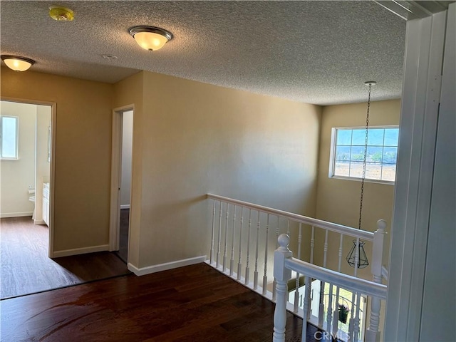 15620 Smoke Tree St, Hesperia, CA 92345 - corridor with wood finished floors, a textured ceiling, and an upstairs landing