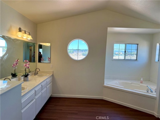 15620 Smoke Tree St, Hesperia, CA 92345 - full bathroom featuring wood finished floors, double vanity, plenty of natural light, a garden tub, and vaulted ceiling