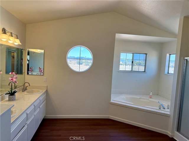 15620 Smoke Tree St, Hesperia, CA 92345 - full bath with wood finished floors, healthy amount of natural light, double vanity, lofted ceiling, and a bath