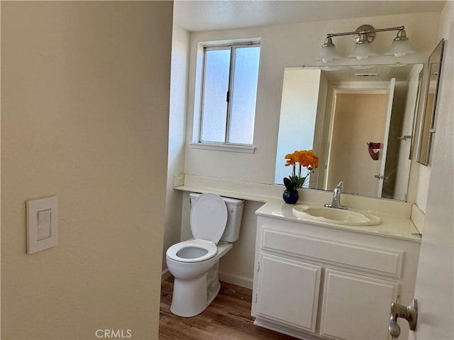 15620 Smoke Tree St, Hesperia, CA 92345 - half bathroom with toilet, vanity, and wood finished floors