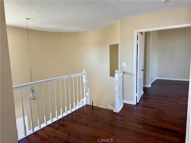 15620 Smoke Tree St, Hesperia, CA 92345 - hallway featuring an upstairs landing, wood finished floors, and a textured ceiling
