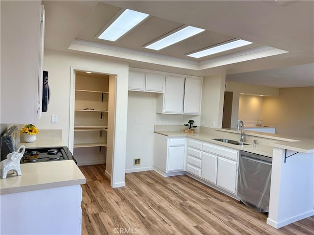 15620 Smoke Tree St, Hesperia, CA 92345 - kitchen with stainless steel dishwasher, a peninsula, light wood-style flooring, and light countertops