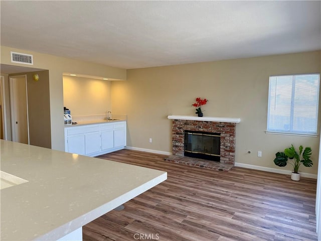 15620 Smoke Tree St, Hesperia, CA 92345 - unfurnished living room with dark wood-style floors and a fireplace