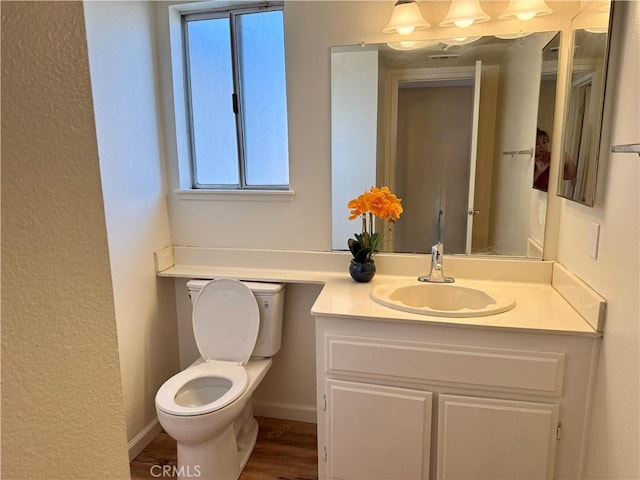 15620 Smoke Tree St, Hesperia, CA 92345 - half bathroom featuring vanity, plenty of natural light, and wood finished floors