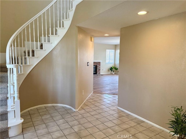 15620 Smoke Tree St, Hesperia, CA 92345 - stairway featuring tile patterned floors, a fireplace, and recessed lighting