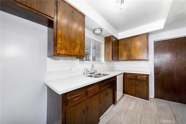 261 E Fig Ave, Monrovia, CA 91016 - kitchen featuring a sink, dishwasher, light countertops, tasteful backsplash, and a raised ceiling
