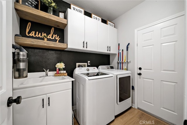 27286 Wedgewood Way, Murrieta, CA 92562 - laundry room with washing machine and dryer, cabinet space, and light wood finished floors