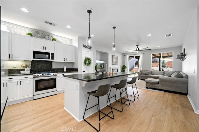 27286 Wedgewood Way, Murrieta, CA 92562 - kitchen featuring stainless steel gas range, light wood-style floors, white cabinetry, a sink, and recessed lighting