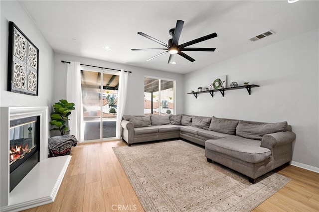 27286 Wedgewood Way, Murrieta, CA 92562 - living room featuring a glass covered fireplace, a ceiling fan, light wood-style floors, recessed lighting, and baseboards