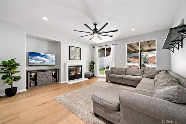 27286 Wedgewood Way, Murrieta, CA 92562 - living room featuring light wood finished floors, ceiling fan, a glass covered fireplace, recessed lighting, and baseboards
