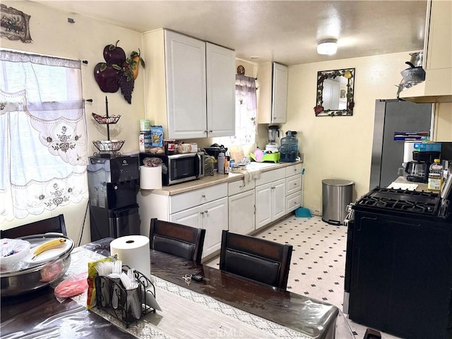 146 W Glendon Way, San Gabriel, CA 91776 - kitchen with appliances with stainless steel finishes, light countertops, and white cabinetry