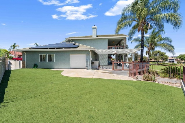 30700 Spyglass Way, Canyon Lake, CA 92587 - back of house with stucco siding, roof mounted solar panels, a garage, and a chimney