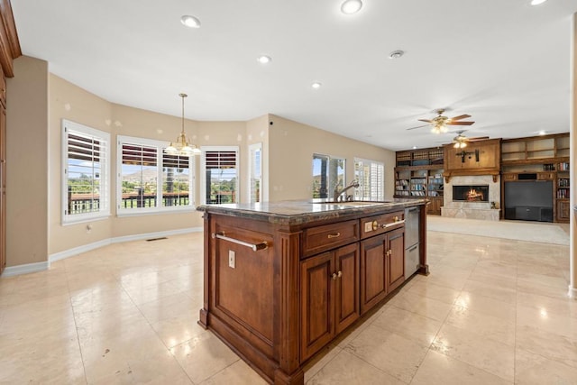 30700 Spyglass Way, Canyon Lake, CA 92587 - kitchen featuring a ceiling fan, a sink, a lit fireplace, baseboards, and light tile patterned floors