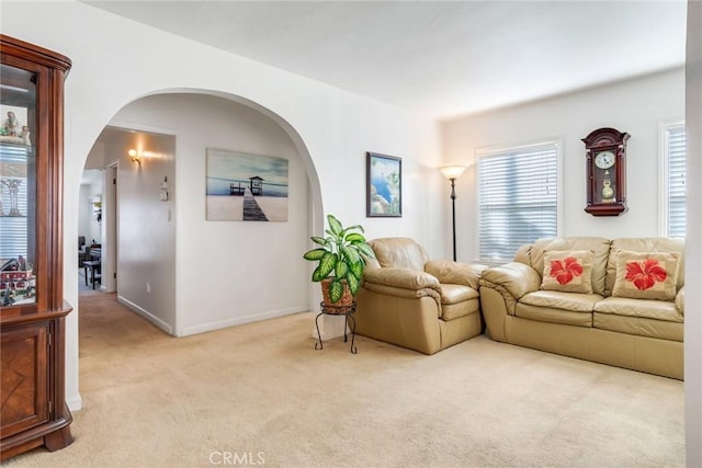 946 W 9th St, Corona, CA 92882 - living room featuring carpet, baseboards, and arched walkways