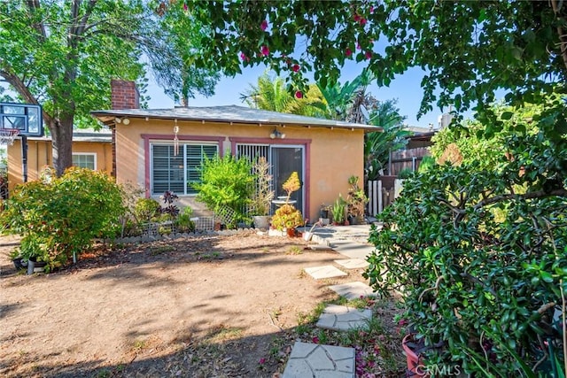 946 W 9th St, Corona, CA 92882 - view of front of home featuring stucco siding and a chimney