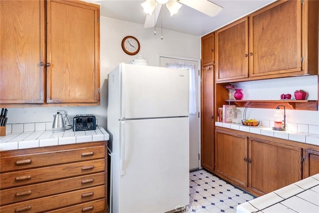 946 W 9th St, Corona, CA 92882 - kitchen featuring freestanding refrigerator, light flooring, ceiling fan, brown cabinets, and open shelves