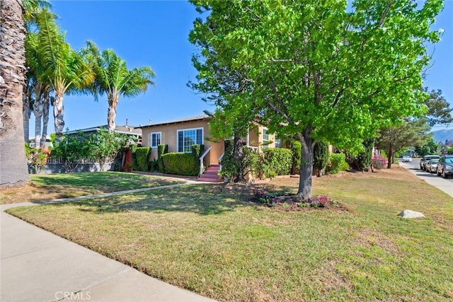 946 W 9th St, Corona, CA 92882 - view of property hidden behind natural elements with a front yard and stucco siding