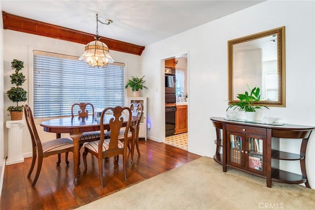 946 W 9th St, Corona, CA 92882 - dining area featuring a chandelier, baseboards, wood finished floors, and carpet floors