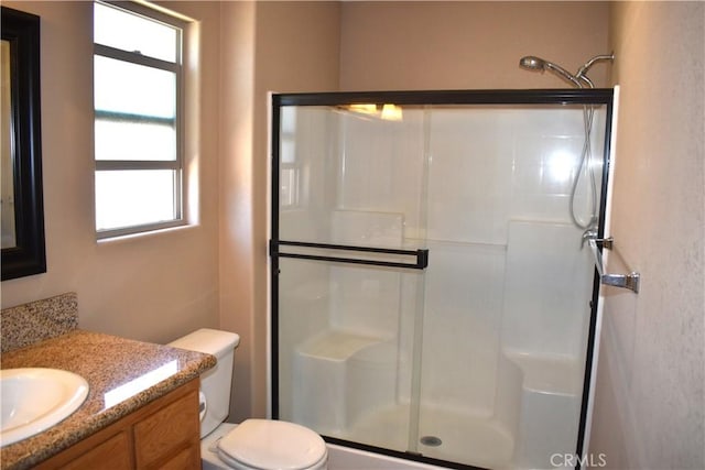 8065 Oxford Ave, Hesperia, CA 92345 - bathroom featuring a stall shower, toilet, and vanity