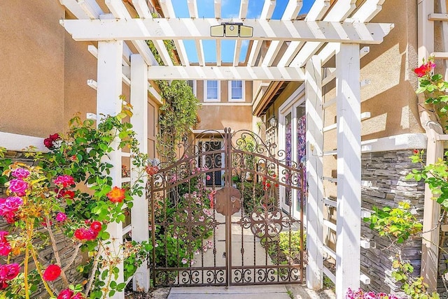 7132 Torrey Mesa Ct, San Diego, CA 92129 - doorway to property featuring a gate, stucco siding, and a pergola
