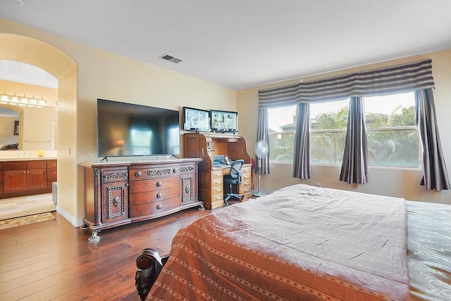7132 Torrey Mesa Ct, San Diego, CA 92129 - bedroom with arched walkways, multiple windows, wood finished floors, and ensuite bathroom