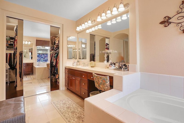 7132 Torrey Mesa Ct, San Diego, CA 92129 - bathroom featuring a spacious closet, a garden tub, vanity, and tile patterned floors