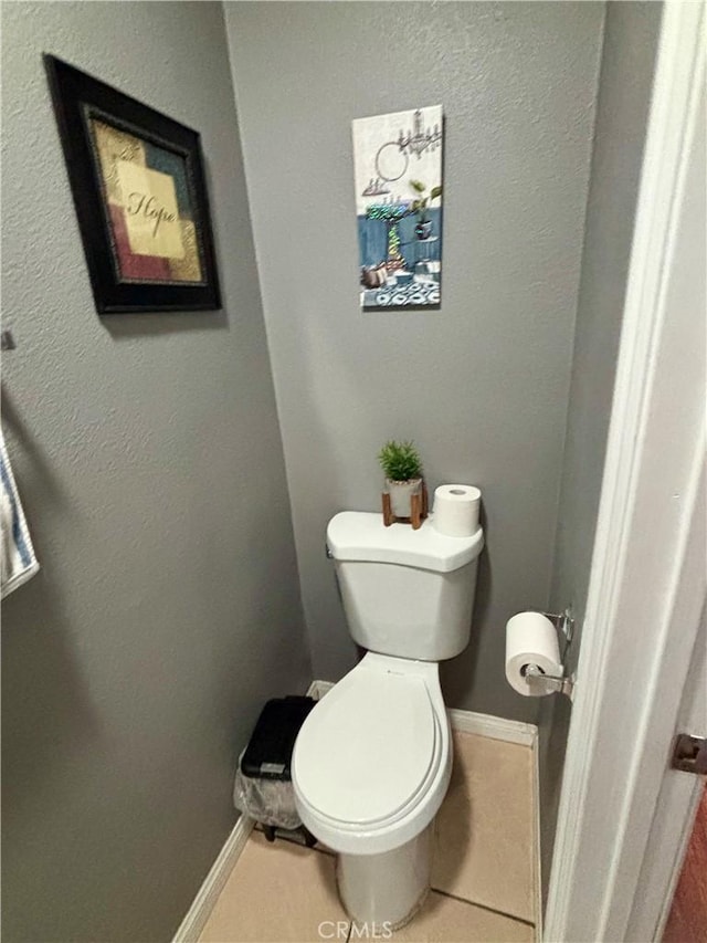 16739 Upland, Fontana, CA 92335 - bathroom with baseboards, toilet, and tile patterned floors