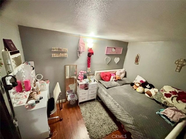 16739 Upland, Fontana, CA 92335 - bedroom featuring wood finished floors and a textured ceiling