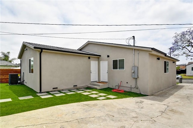 10806 S St Andrews Pl, Los Angeles, CA 90047 - rear view of property featuring stucco siding, a patio, central AC, and crawl space