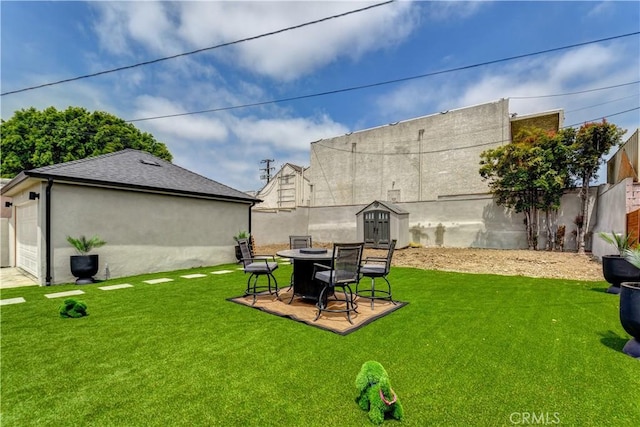 10806 S St Andrews Pl, Los Angeles, CA 90047 - view of yard featuring an outdoor fire pit and a garage