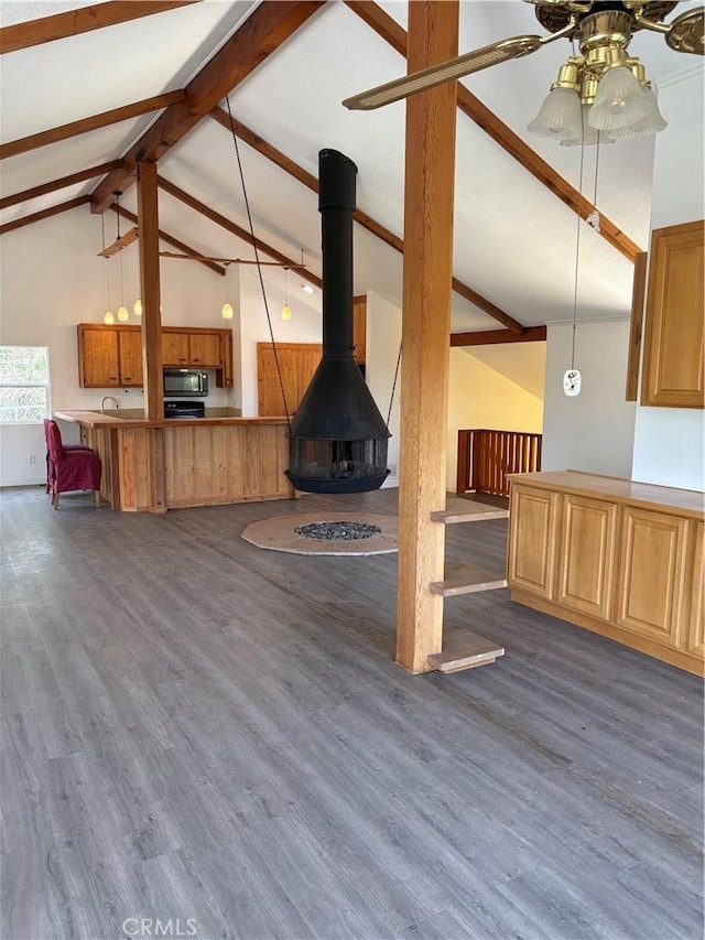 22555 Fern Ann Falls Rd, Chatsworth, CA 91311 - unfurnished living room with dark wood-style floors, a ceiling fan, a sink, and a wood stove
