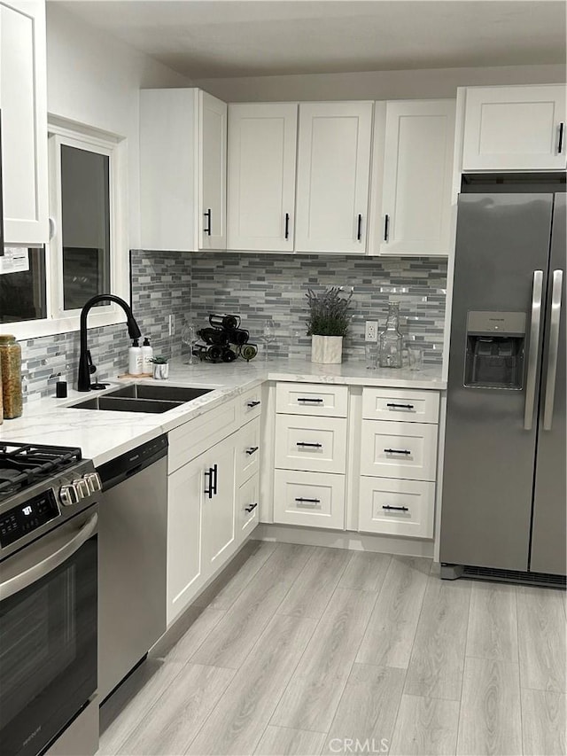 8916 Mettler Ave, Los Angeles, CA 90003 - kitchen with stainless steel appliances, a sink, and white cabinets