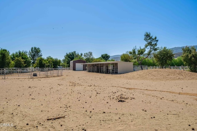 35135 Caprock Rd, Santa Clarita, CA 91390 - view of yard featuring an outdoor structure, an exterior structure, an outdoor riding arena, and a mountain view