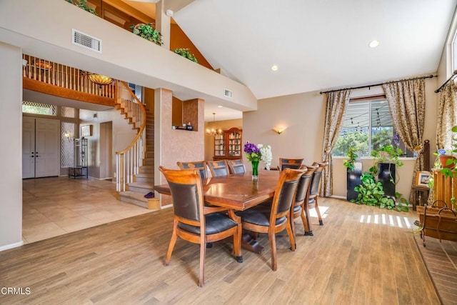35135 Caprock Rd, Santa Clarita, CA 91390 - dining space featuring high vaulted ceiling, stairs, light wood-style floors, and a chandelier