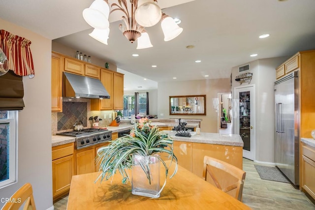 35135 Caprock Rd, Santa Clarita, CA 91390 - kitchen with ventilation hood, stainless steel appliances, a chandelier, light countertops, and light wood-type flooring