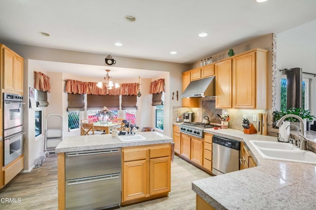 35135 Caprock Rd, Santa Clarita, CA 91390 - kitchen featuring appliances with stainless steel finishes, under cabinet range hood, plenty of natural light, a chandelier, and recessed lighting