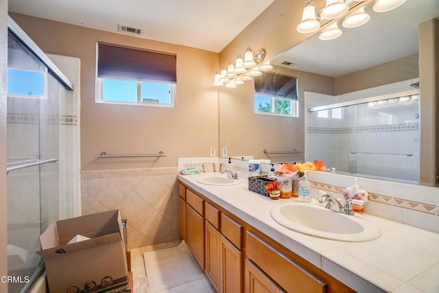 35135 Caprock Rd, Santa Clarita, CA 91390 - bathroom featuring tile walls, healthy amount of natural light, double vanity, tiled shower, and tile patterned flooring