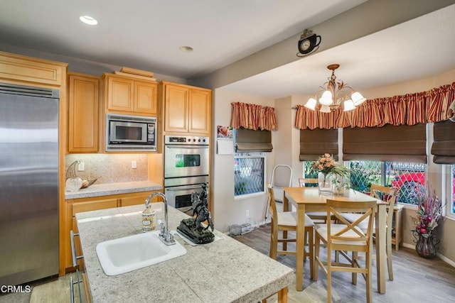 35135 Caprock Rd, Santa Clarita, CA 91390 - kitchen featuring stainless steel appliances, light countertops, a chandelier, light wood finished floors, and recessed lighting