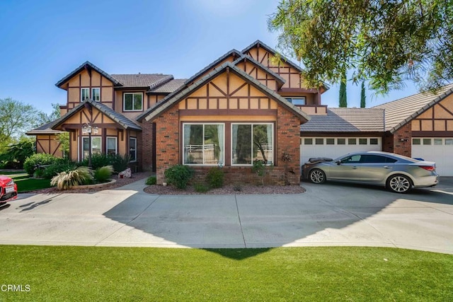 35135 Caprock Rd, Santa Clarita, CA 91390 - tudor-style house featuring driveway, a garage, brick siding, stucco siding, and a front lawn