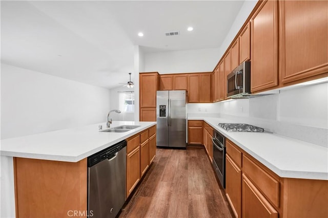 30268 Cherry Opal Ln, Menifee, CA 92584 - kitchen with stainless steel appliances, a sink, dark wood-style flooring, a ceiling fan, and light countertops